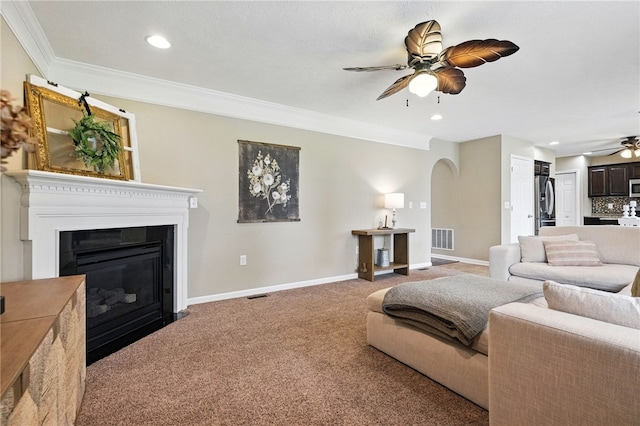 412 Colt Cir, Findlay Twp, PA 15026 - carpeted living area with ceiling fan, arched walkways, crown molding, a glass covered fireplace, and recessed lighting