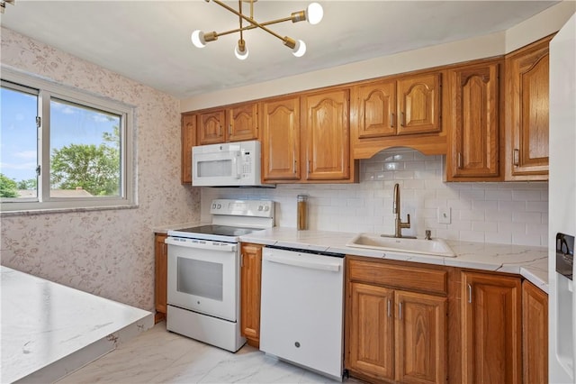 809 Limestone Dr, Shaler, PA 15101 - kitchen with white appliances, light marble finish floors, light countertops, brown cabinetry, and a chandelier