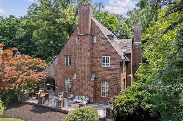 1808 Beechwood Blvd, Squirrel Hill, PA 15217 - view of side of property with a chimney, a patio area, and brick siding