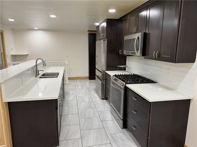 2350 Mount Vernon Ave, Murrysville, PA 15632 - kitchen featuring appliances with stainless steel finishes, decorative backsplash, a kitchen island with sink, light countertops, and dark brown cabinetry