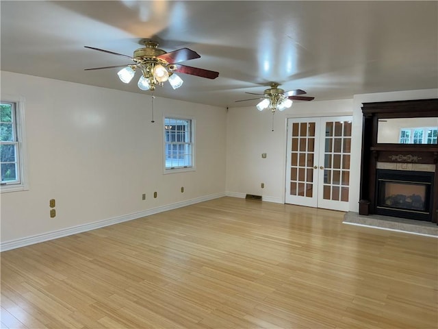2350 Mount Vernon Ave, Murrysville, PA 15632 - unfurnished living room with light wood-style floors, french doors, ceiling fan, and healthy amount of natural light