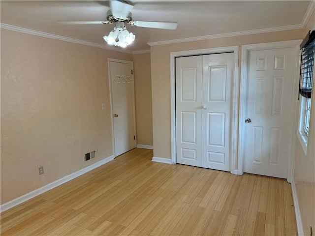 2350 Mount Vernon Ave, Murrysville, PA 15632 - unfurnished bedroom with light wood-type flooring, crown molding, a ceiling fan, and a closet