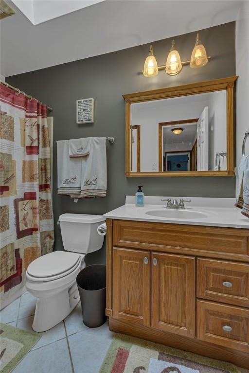 2203 14th St, Patterson Twp, PA 15010 - bathroom with vanity, tile patterned flooring, a skylight, and a shower with curtain
