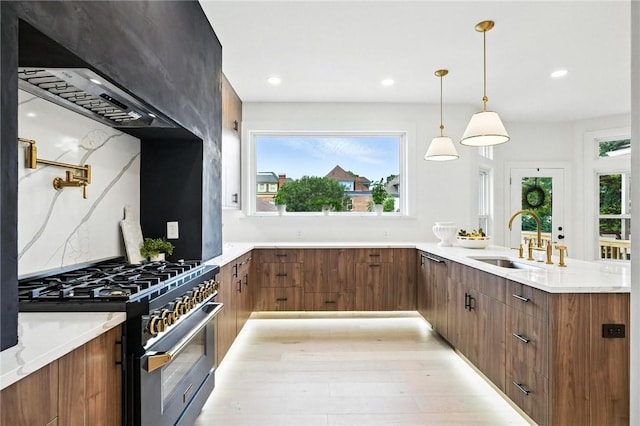 605 N Beatty, East Liberty, PA 15206 - kitchen featuring stainless steel gas stove, wall chimney exhaust hood, a peninsula, brown cabinets, and recessed lighting