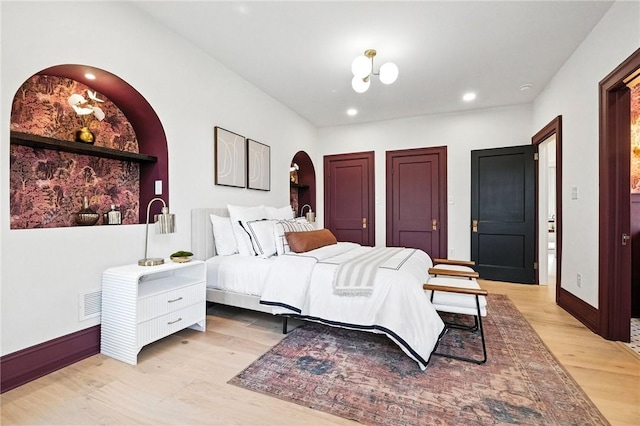 605 N Beatty, East Liberty, PA 15206 - bedroom with light wood-type flooring, arched walkways, recessed lighting, and two closets