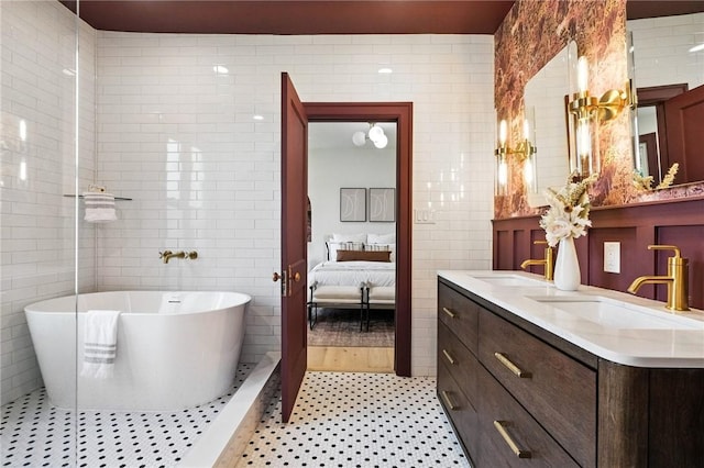 605 N Beatty, East Liberty, PA 15206 - ensuite bathroom with tile walls, double vanity, a freestanding tub, and tile patterned floors