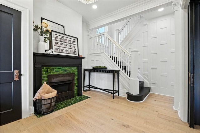605 N Beatty, East Liberty, PA 15206 - foyer featuring a fireplace with flush hearth, stairway, wood finished floors, ornamental molding, and recessed lighting