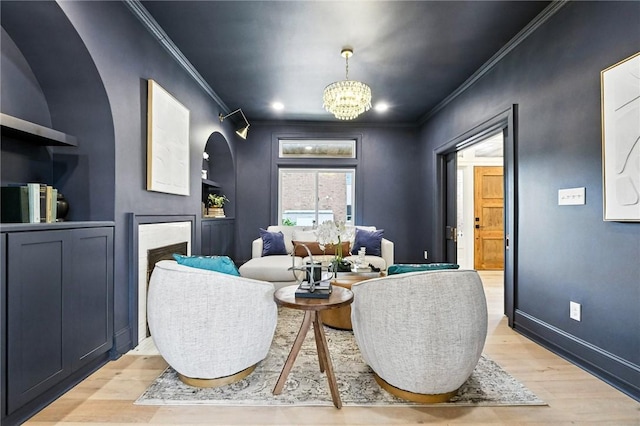 605 N Beatty, East Liberty, PA 15206 - sitting room with ornamental molding, light wood-type flooring, a chandelier, a fireplace, and arched walkways