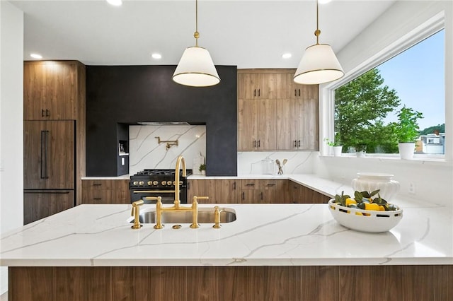 605 N Beatty, East Liberty, PA 15206 - kitchen with light stone countertops, recessed lighting, stainless steel range, and pendant lighting