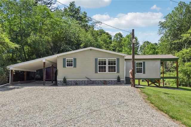 171 Fetter Ln, Ligonier Twp, PA 15658 - manufactured / mobile home with driveway, a front lawn, and a carport