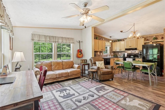 171 Fetter Ln, Ligonier Twp, PA 15658 - living room featuring vaulted ceiling, a chandelier, light wood-type flooring, a textured ceiling, and ceiling fan