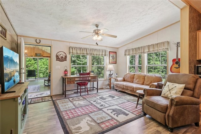 171 Fetter Ln, Ligonier Twp, PA 15658 - living area with lofted ceiling, a textured ceiling, ceiling fan, wood finished floors, and crown molding