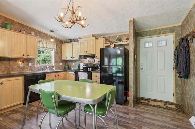 171 Fetter Ln, Ligonier Twp, PA 15658 - kitchen featuring black appliances, a chandelier, under cabinet range hood, vaulted ceiling, and dark countertops