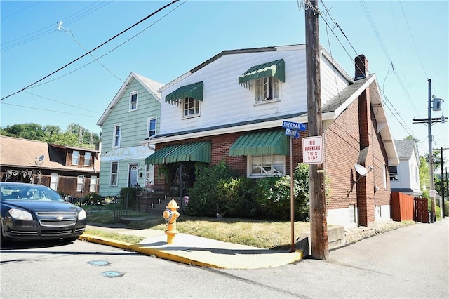 300 Sherman Ave, Dravosburg, PA 15034 - view of front facade with brick siding and a chimney