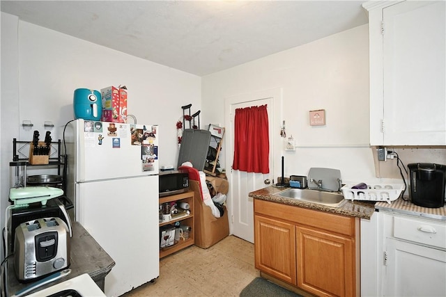 300 Sherman Ave, Dravosburg, PA 15034 - kitchen featuring freestanding refrigerator, stainless steel microwave, and white cabinets