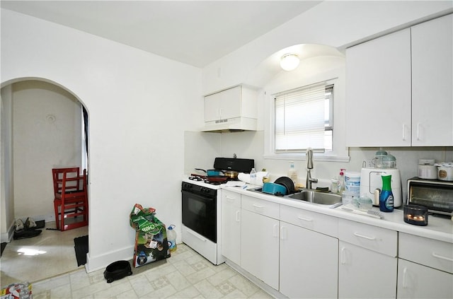 300 Sherman Ave, Dravosburg, PA 15034 - kitchen featuring white range with gas cooktop, under cabinet range hood, light countertops, white cabinets, and light flooring