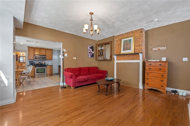 98 S 9th St, South Side, PA 15203 - living area featuring light wood-style flooring and a chandelier