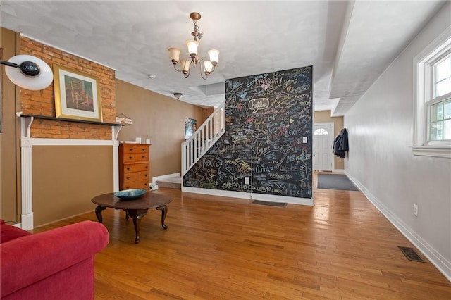 98 S 9th St, South Side, PA 15203 - living room with wood finished floors, a chandelier, and stairway