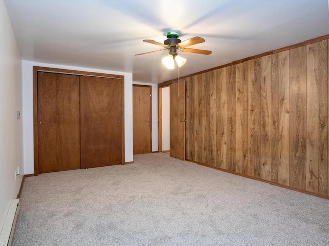 3105 Bennetts Run Rd, North Sewickley Twp, PA 15010 - unfurnished bedroom with carpet floors, a baseboard radiator, wooden walls, two closets, and a ceiling fan