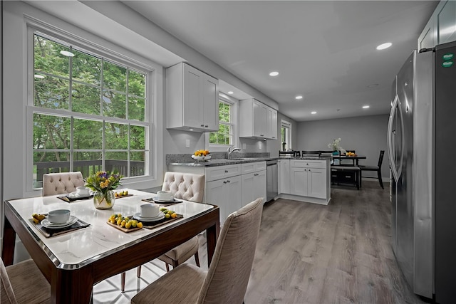 240 Wallingford Dr, Ross Twp, PA 15237 - kitchen featuring appliances with stainless steel finishes, a peninsula, white cabinets, light wood finished floors, and recessed lighting