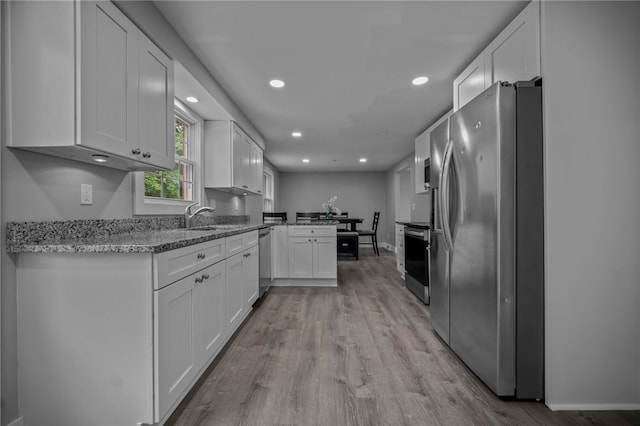 240 Wallingford Dr, Ross Twp, PA 15237 - kitchen with appliances with stainless steel finishes, a peninsula, light wood finished floors, white cabinets, and recessed lighting
