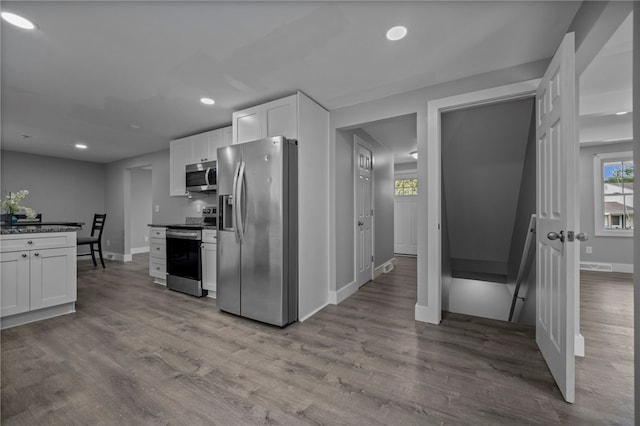 240 Wallingford Dr, Ross Twp, PA 15237 - kitchen featuring stainless steel appliances, white cabinetry, wood finished floors, recessed lighting, and dark countertops