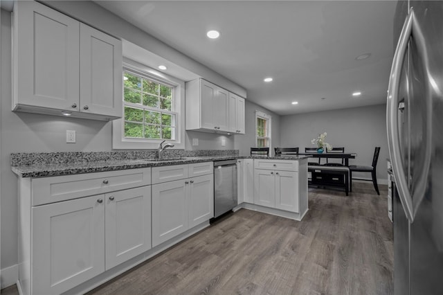 240 Wallingford Dr, Ross Twp, PA 15237 - kitchen with stainless steel appliances, healthy amount of natural light, wood finished floors, a peninsula, and recessed lighting