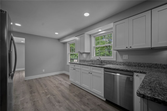 240 Wallingford Dr, Ross Twp, PA 15237 - kitchen featuring appliances with stainless steel finishes, recessed lighting, wood finished floors, dark stone countertops, and white cabinetry