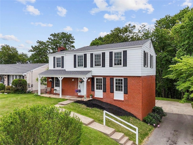 240 Wallingford Dr, Ross Twp, PA 15237 - view of front of house with brick siding, a porch, a chimney, and a front yard