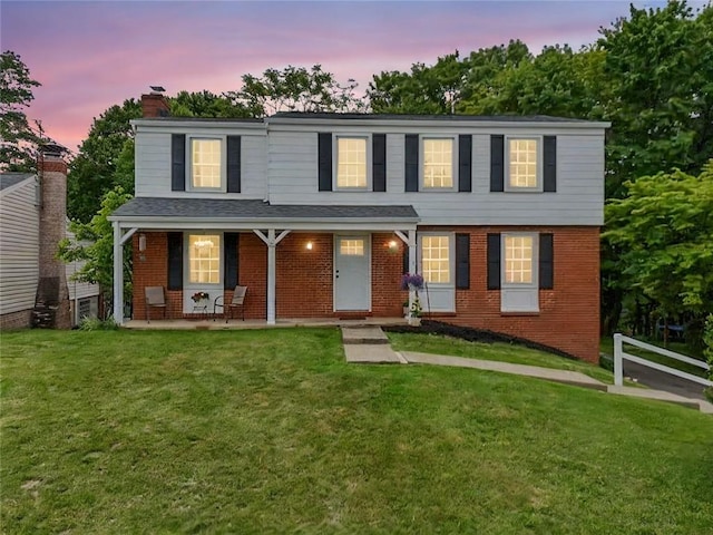 240 Wallingford Dr, Ross Twp, PA 15237 - view of front of house with a chimney, brick siding, a porch, and a lawn
