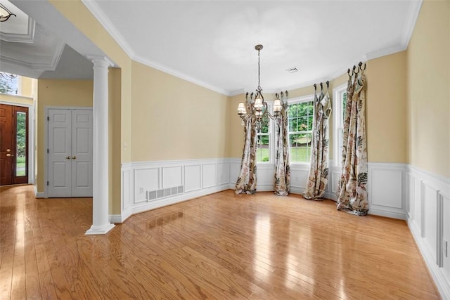 402 Providence Ct, Adams Twp, PA 16059 - unfurnished dining area with healthy amount of natural light, ornate columns, light wood-style flooring, a wainscoted wall, and ornamental molding