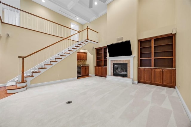 402 Providence Ct, Adams Twp, PA 16059 - unfurnished living room featuring a high ceiling, stairway, beamed ceiling, light colored carpet, and a fireplace
