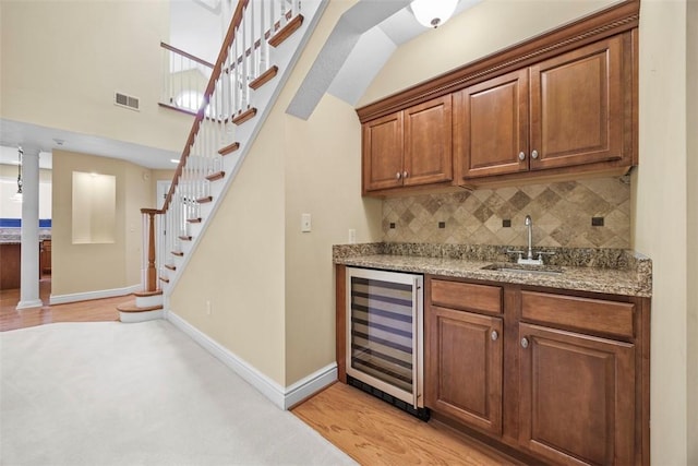 402 Providence Ct, Adams Twp, PA 16059 - indoor wet bar featuring wine cooler, stairway, decorative backsplash, and light wood-style floors