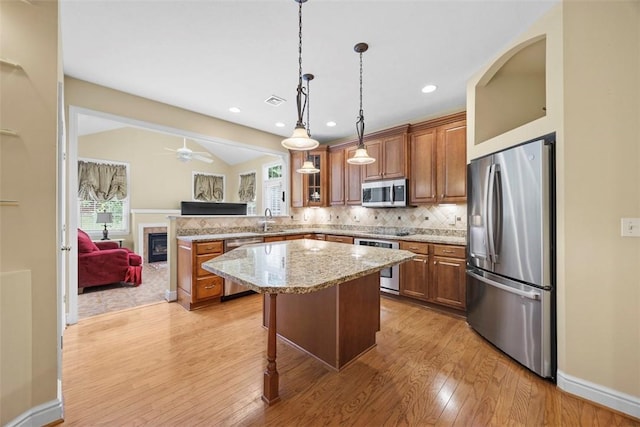 402 Providence Ct, Adams Twp, PA 16059 - kitchen featuring stainless steel appliances, brown cabinets, light wood-style floors, recessed lighting, and vaulted ceiling