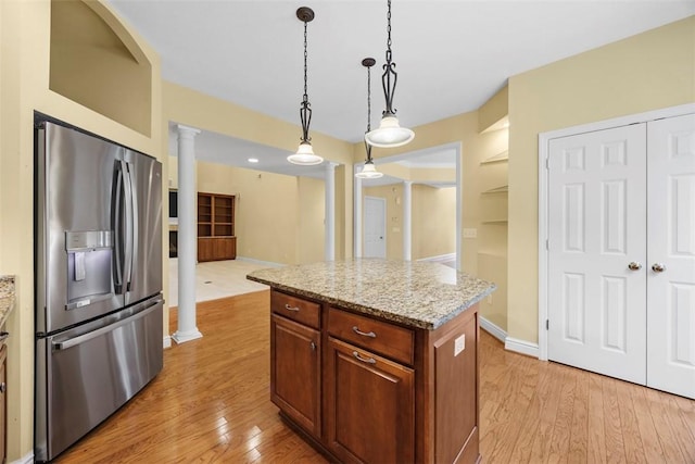 402 Providence Ct, Adams Twp, PA 16059 - kitchen with stainless steel refrigerator with ice dispenser, ornate columns, light wood-style flooring, decorative light fixtures, and a center island