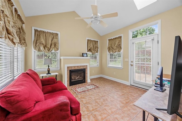 402 Providence Ct, Adams Twp, PA 16059 - tiled living room with a tiled fireplace, a ceiling fan, a skylight, and high vaulted ceiling