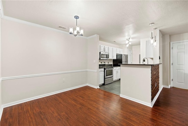 3011 Lenox Oval, Ross Twp, PA 15237 - kitchen featuring appliances with stainless steel finishes, dark countertops, a chandelier, a peninsula, and white cabinets
