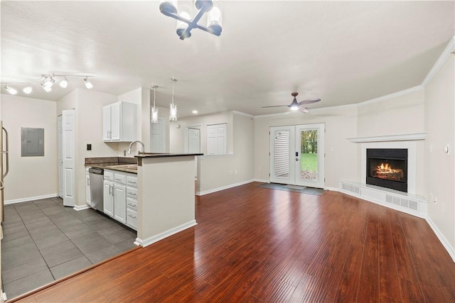 3011 Lenox Oval, Ross Twp, PA 15237 - kitchen with dark countertops, electric panel, a warm lit fireplace, stainless steel dishwasher, and a chandelier