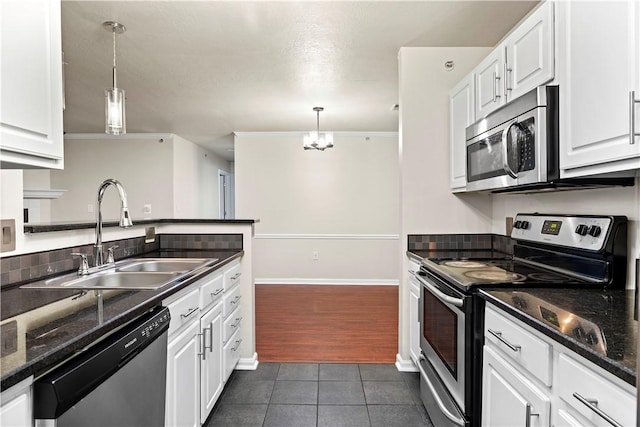 3011 Lenox Oval, Ross Twp, PA 15237 - kitchen featuring appliances with stainless steel finishes, dark tile patterned flooring, white cabinetry, and ornamental molding