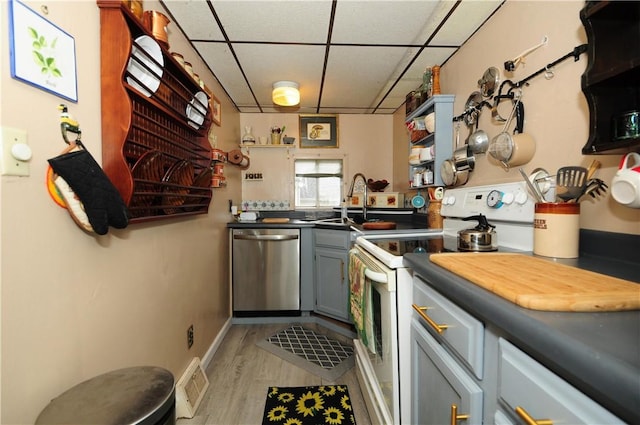 2 Mccormick Ave, Uniontown, PA 15401 - kitchen with stainless steel dishwasher, electric range, a paneled ceiling, light wood-style floors, and gray cabinets