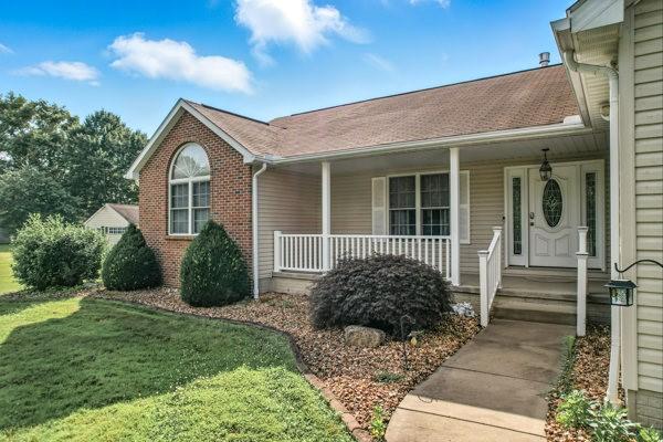 3129 Saranac Dr, South Pymatuning Twp, PA 16150 - view of front facade with covered porch, a front lawn, brick siding, and roof with shingles