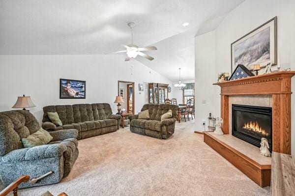 3129 Saranac Dr, South Pymatuning Twp, PA 16150 - carpeted living room with vaulted ceiling, a glass covered fireplace, a ceiling fan, and a chandelier