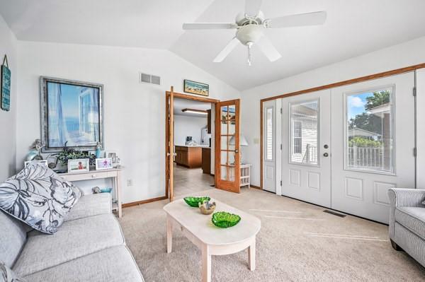 3129 Saranac Dr, South Pymatuning Twp, PA 16150 - living area with french doors, lofted ceiling, light colored carpet, and ceiling fan
