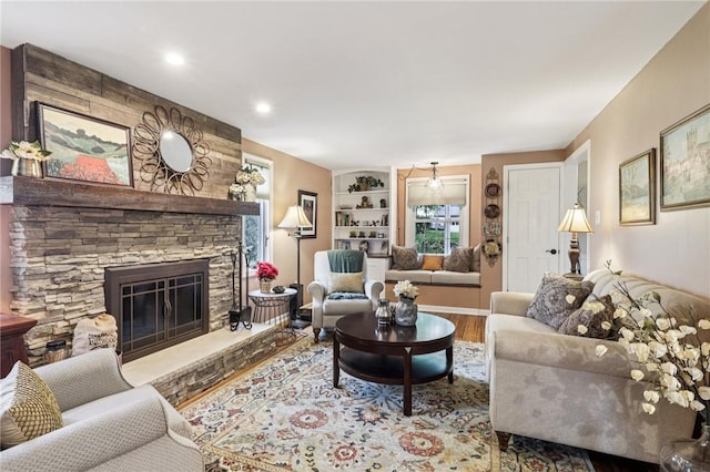 108 Colonial Dr, Leet Twp, PA 15143 - living room featuring wood finished floors, a fireplace, and built in features