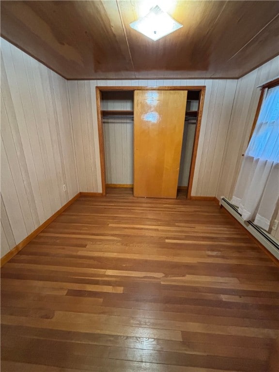 184 Chestnut St, Center Twp/Homer Cty, PA 15731 - unfurnished bedroom with light wood-style floors, wooden walls, a baseboard radiator, and wood ceiling
