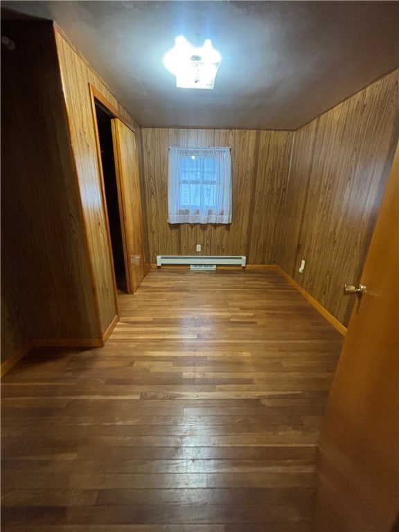 184 Chestnut St, Center Twp/Homer Cty, PA 15731 - spare room featuring a baseboard radiator, wood finished floors, and wooden walls