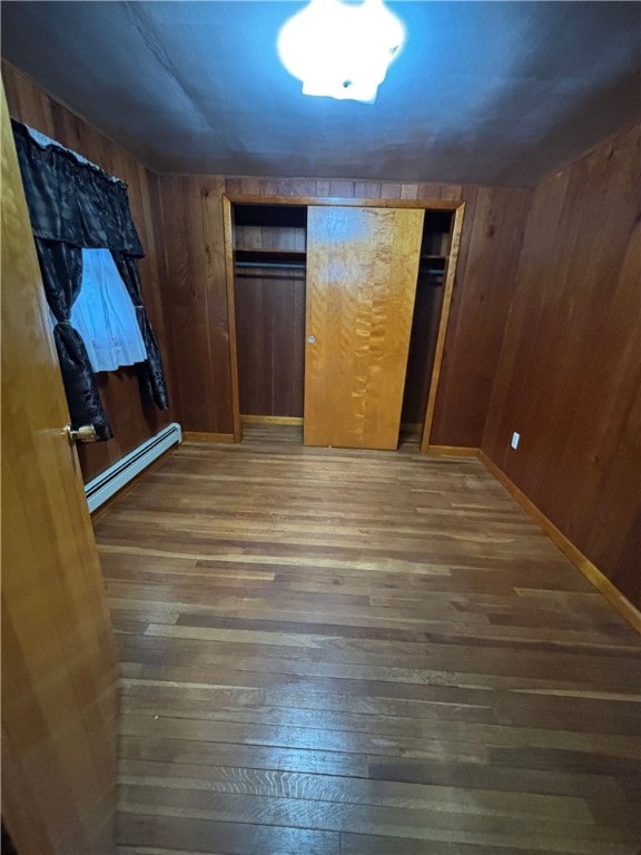 184 Chestnut St, Center Twp/Homer Cty, PA 15731 - unfurnished bedroom featuring baseboard heating, wood finished floors, and wood walls
