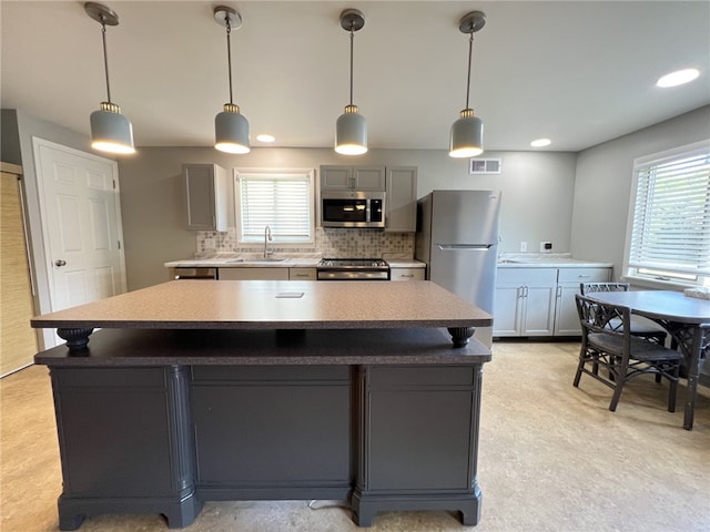 43 Barton Mill Rd, South Union Twp, PA 15401 - kitchen with stainless steel appliances, backsplash, gray cabinetry, a center island, and hanging light fixtures