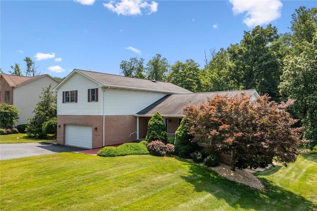 915 Jamell Dr, Unity Twp, PA 15601 - view of front of property with driveway, an attached garage, a front yard, and brick siding