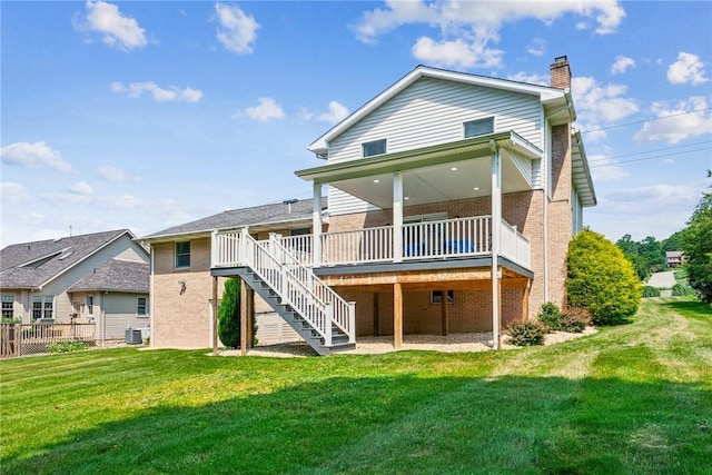 915 Jamell Dr, Unity Twp, PA 15601 - back of property featuring brick siding, a chimney, stairway, and a yard
